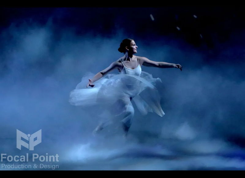 Ballet dancer dancing through low-lying fog, creating a dreamy, fantasy-style effect on stage